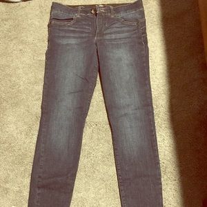 A pair of dark blue denim jeans